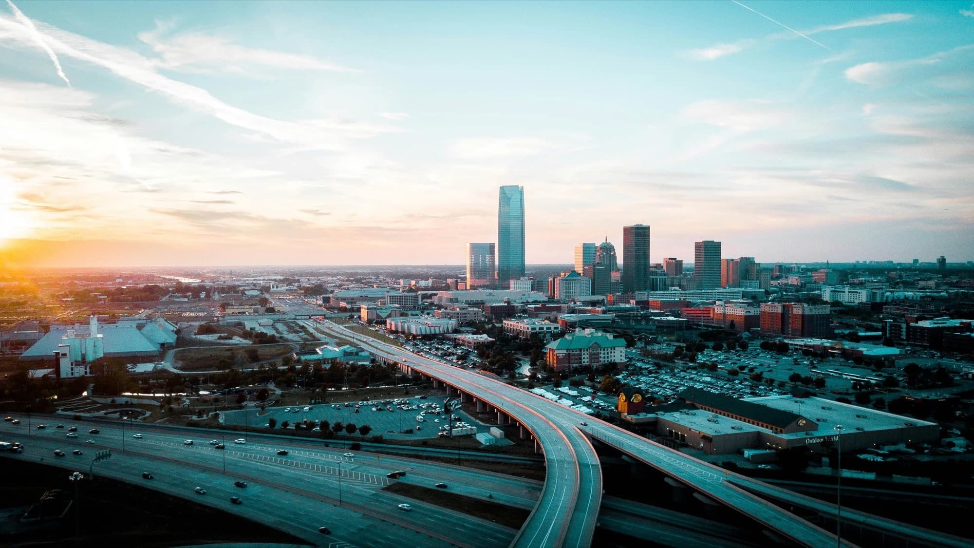 The Oklahoma City skyline at sunset with highways in the foreground